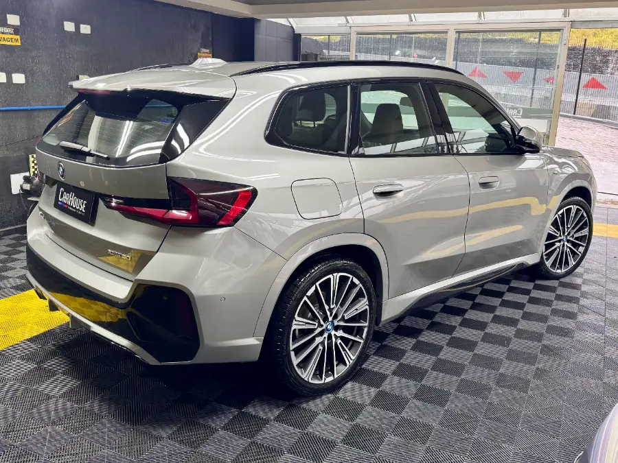 BMW iX1 M Sport cinza — lateral — na oficina premium da CarHouse em Curitiba